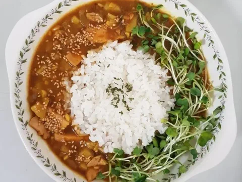 Curry picante de pechuga de pollo, servido con arroz y brotes
