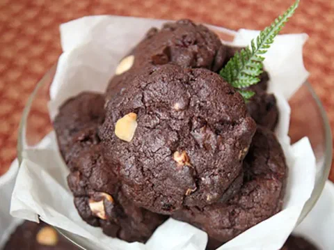 Galletas de macadamia y chocolate, con la macadamia tostada asomando entre el chocolate