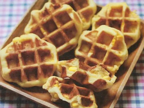 Waffles de Lieja partidos mostrando granos de choclo y queso derretido adentro